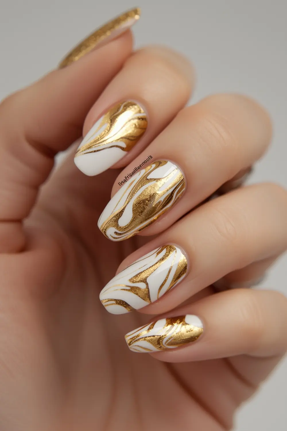 2. Molten Metal Marble: Swirled Gold & White Nail Art